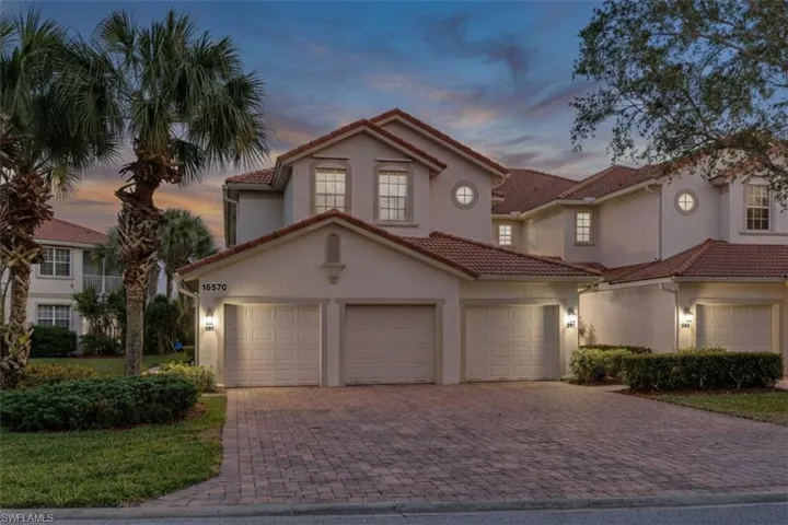 Mediterranean / spanish house featuring decorative driveway, stucco siding, and a tiled roof