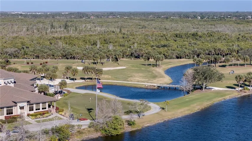 Drone / aerial view of a large body of water and a local golf course