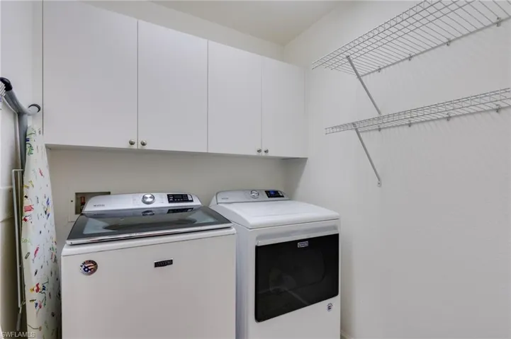 Laundry room featuring cabinet space and washer and dryer