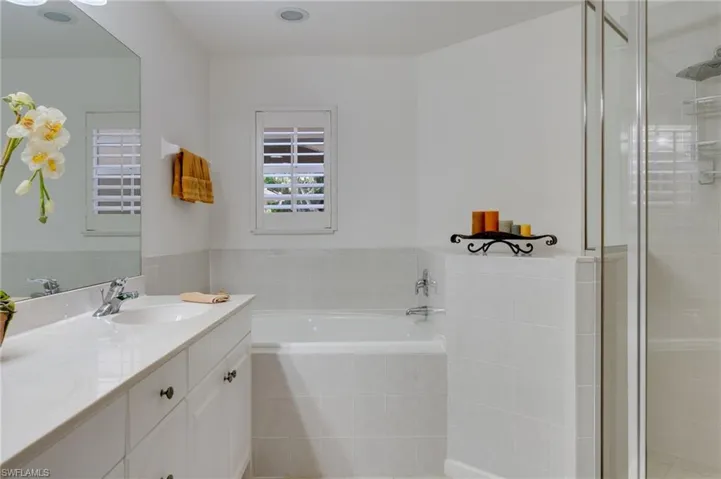 Full bathroom featuring vanity, a bath, and a stall shower