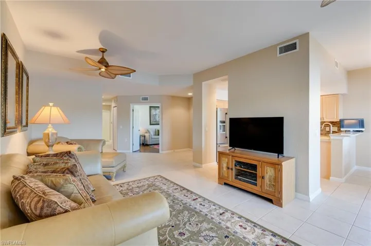 Living room featuring a ceiling fan and light tile patterned floors