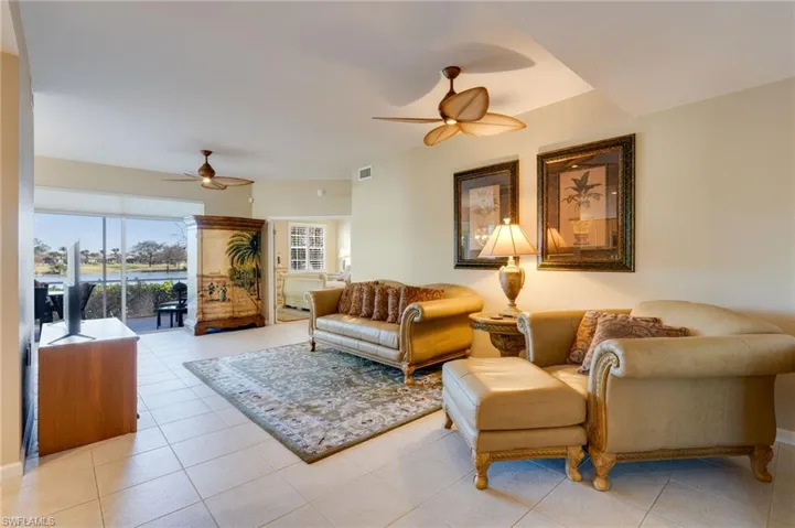 Living room featuring ceiling fan and light tile patterned flooring