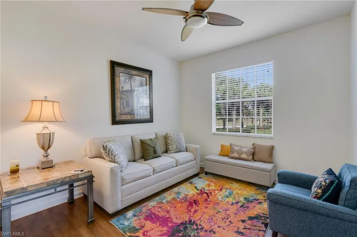Living room with wood finished floors and a ceiling fan