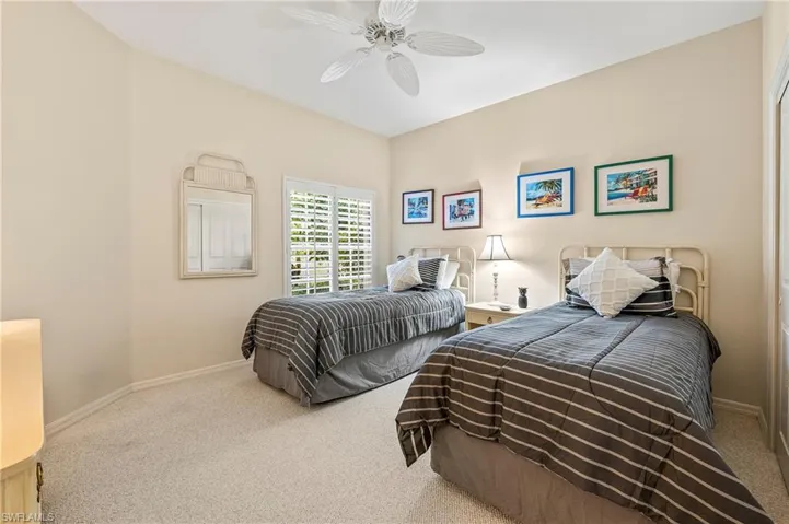 Bedroom with ceiling fan and carpet