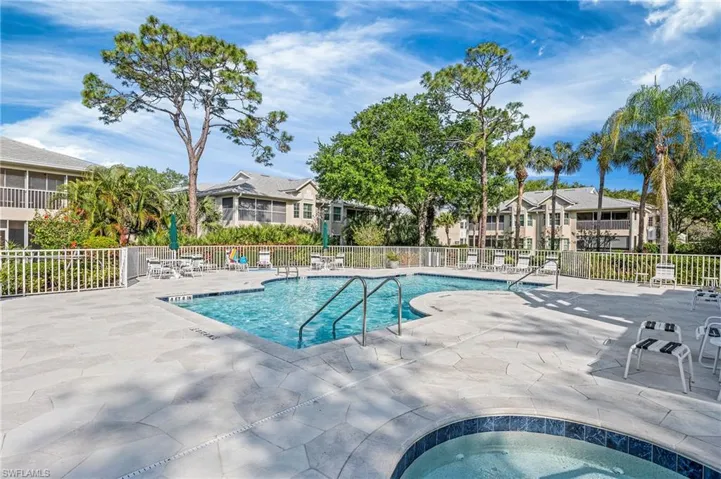 View of swimming pool with a patio area and a community hot tub