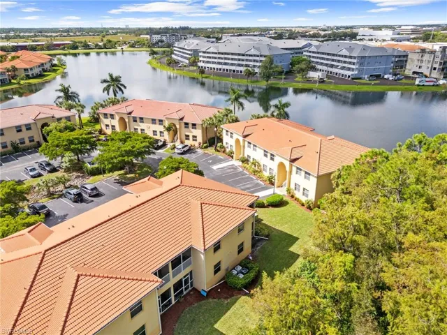 Drone / aerial view of apartment complex / building and a nearby body of water
