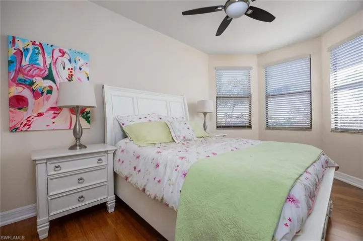 Bedroom featuring dark wood-style floors and ceiling fan