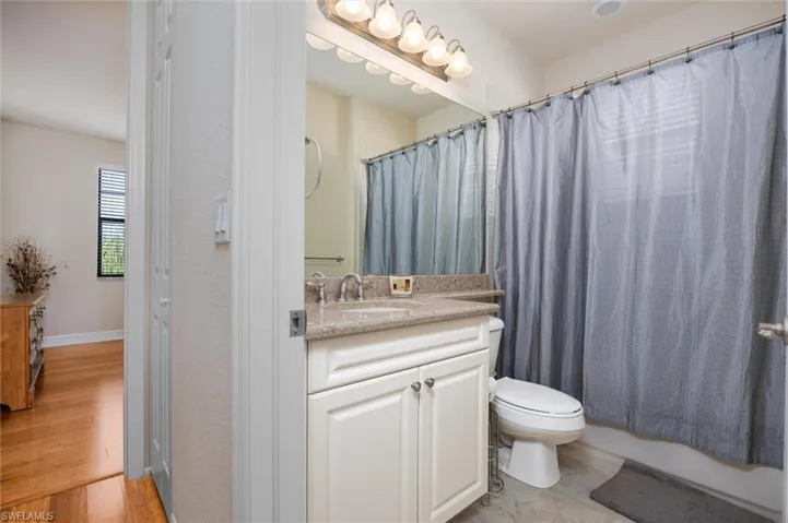Full bath featuring vanity and shower / bath combo with shower curtain