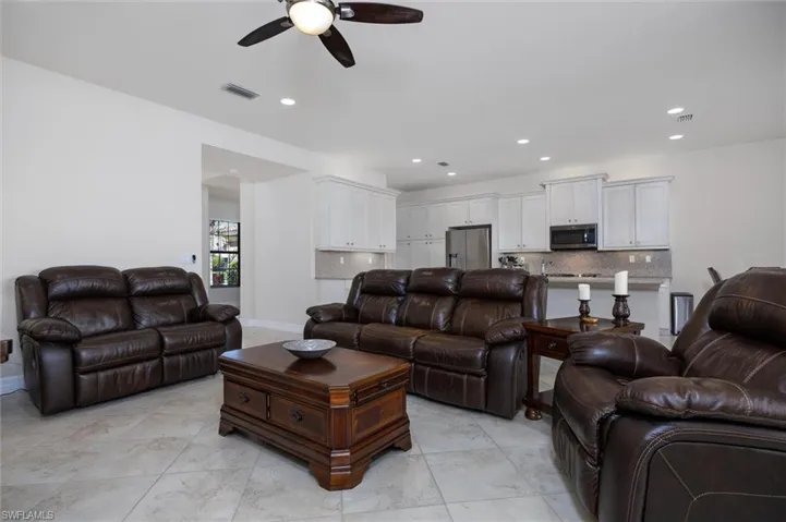 Living room with ceiling fan and recessed lighting