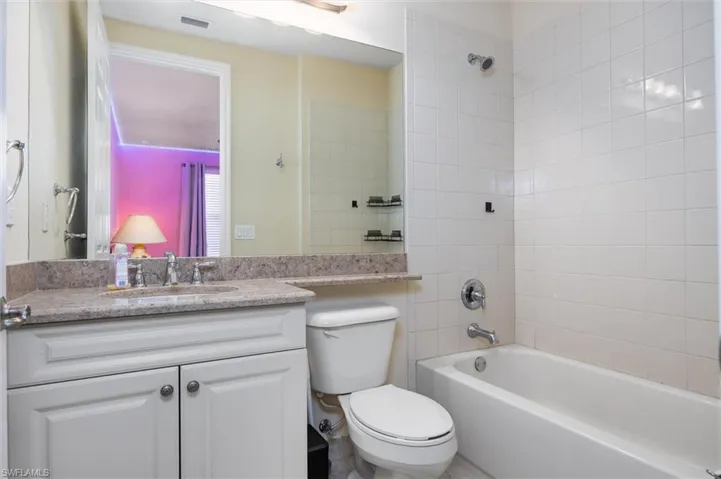 Bathroom with vanity and washtub / shower combination