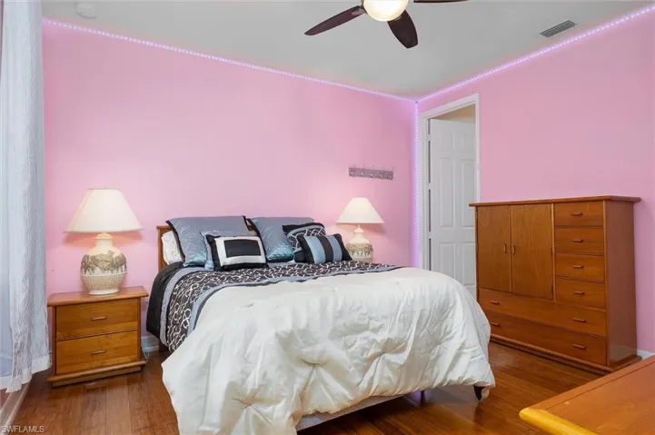 Bedroom with ceiling fan and dark wood finished floors
