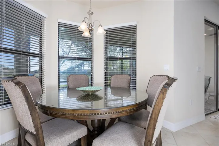 Dining area featuring baseboards and hanging lights