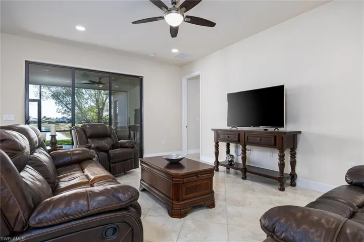 Living area featuring a ceiling fan and recessed lighting