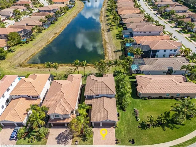 Aerial view of residential area featuring a nearby body of water