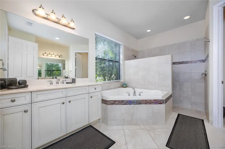 Full bath with walk in shower, vanity, a bath, and recessed lighting