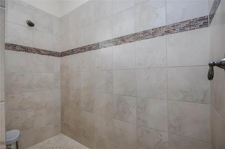 Full bath featuring tiled shower