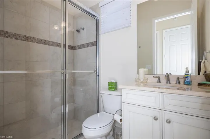 Bathroom featuring vanity and a stall shower