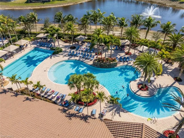 Community pool featuring a water view and a patio area