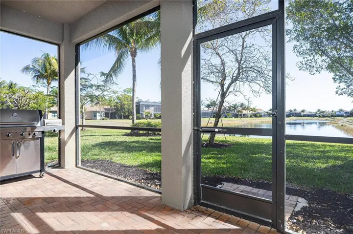 Unfurnished sunroom with a water view and a residential view