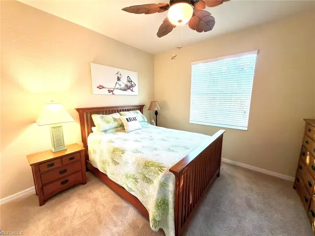 Bedroom featuring light colored carpet and ceiling fan