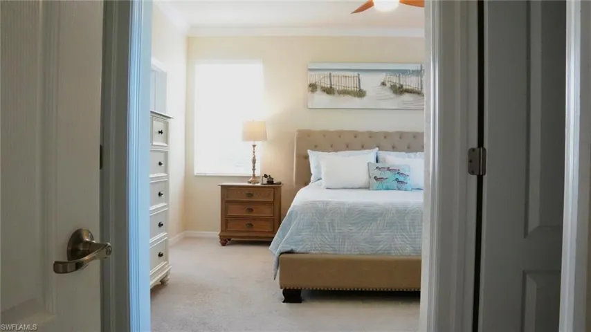 Bedroom with carpet, crown molding, and ceiling fan