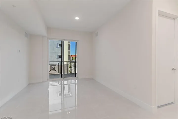 Room featuring a sliding glass door to a balcony with black metal railings