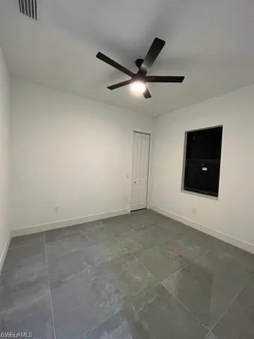 Unfurnished room featuring baseboards and a ceiling fan