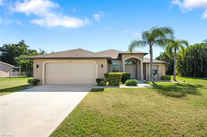 View of front of house featuring stucco siding, a front lawn, driveway, a garage, and roof with shingles