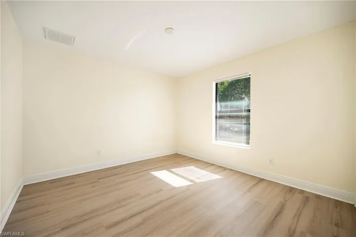 Empty room with light wood finished floors and baseboards