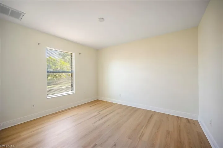 Empty room featuring light wood-type flooring and baseboards