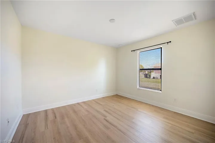 Spare room with light wood-style flooring and baseboards