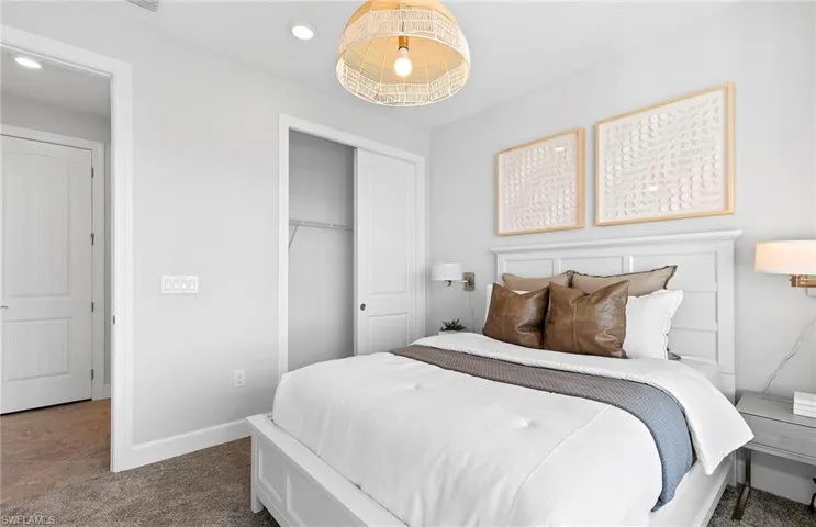 Bedroom with dark colored carpet and a closet