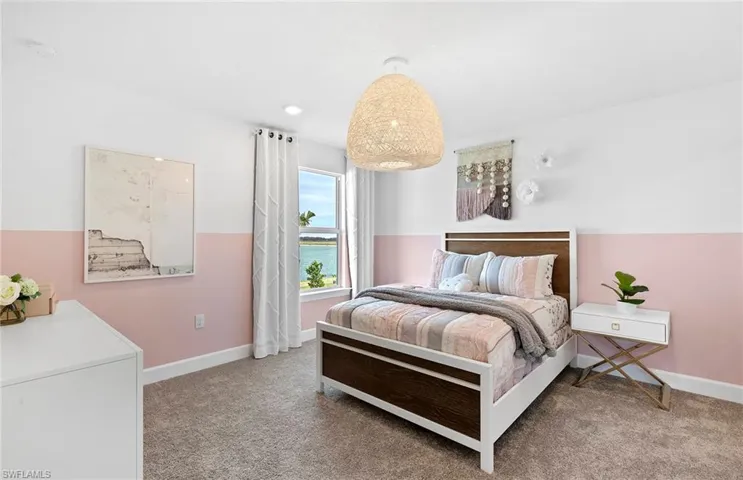 Carpeted bedroom with a water view