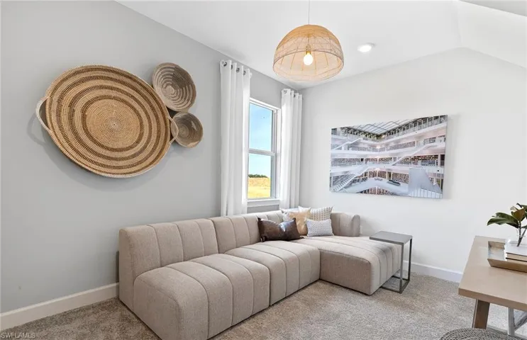 Living room featuring carpet floors and lofted ceiling