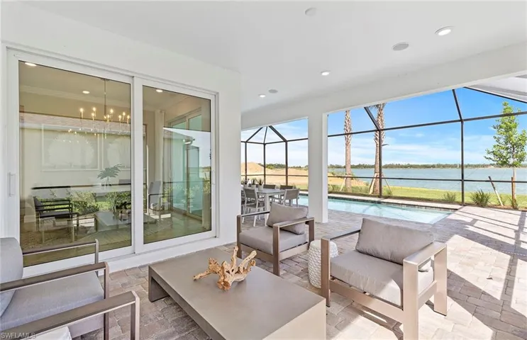 Sunroom / solarium with a water view and a chandelier
