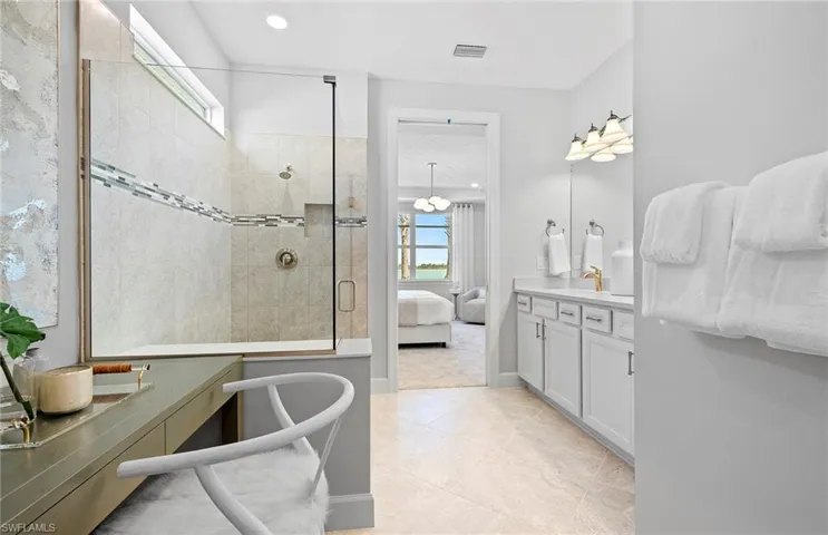 Bathroom with independent shower and bath, vanity, and tile patterned flooring