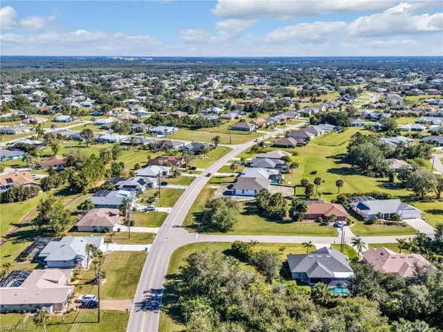 Aerial overview of property's location featuring nearby suburban area