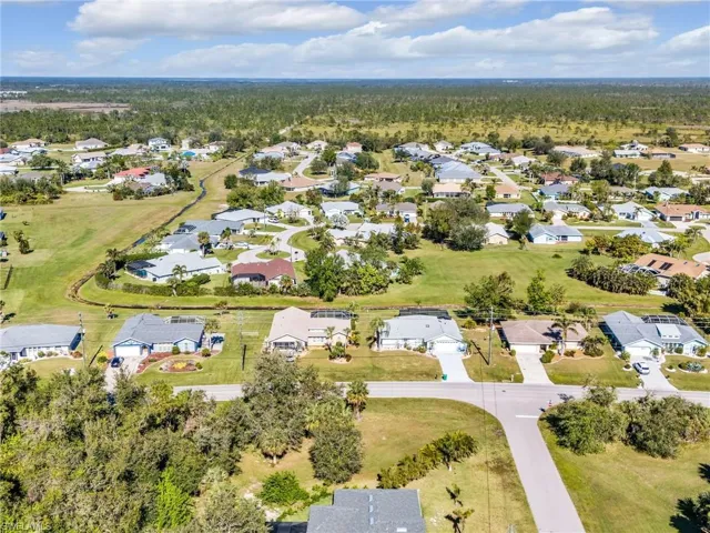 Aerial view of property's location with nearby suburban area