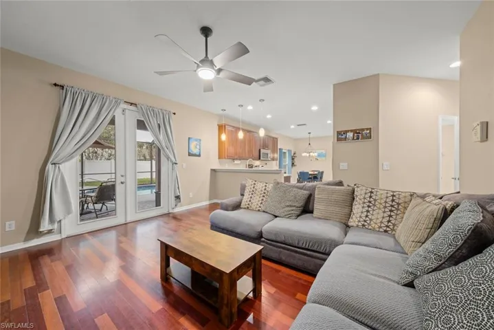 Family room with ceiling fan and wood-style flooring