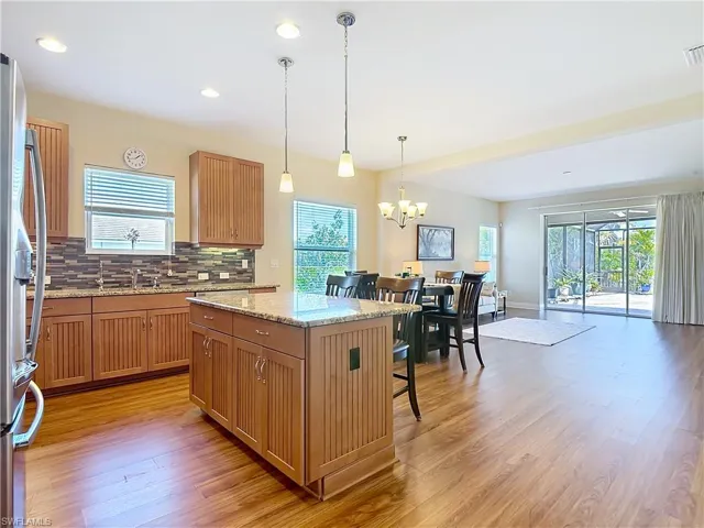 Beautiful tall Maple cabinets with granite counters and glass back splash