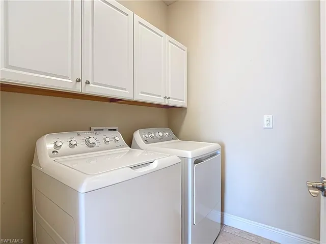 Laundry room has cabinet space and shelfs