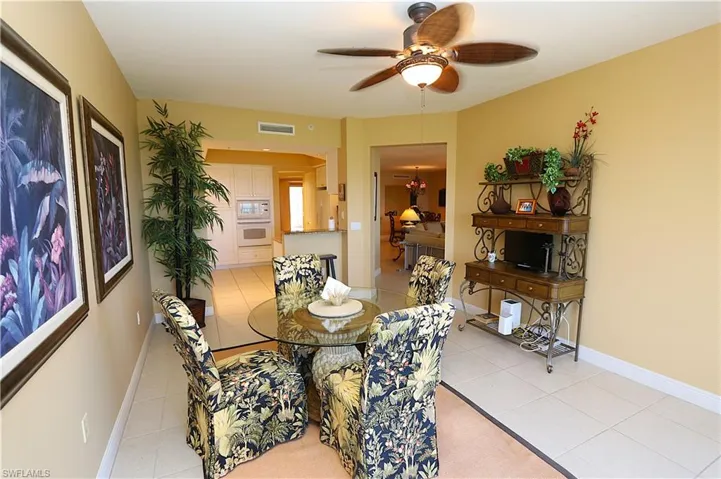 Dining area featuring light tile patterned flooring and a ceiling fan