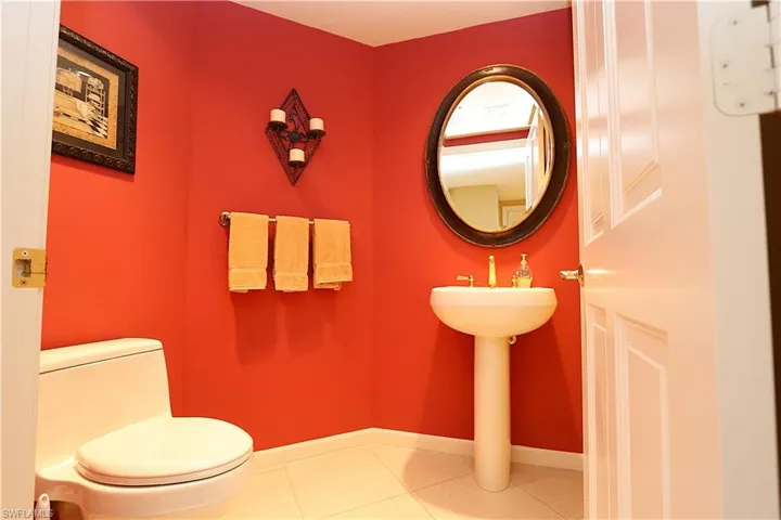 Bathroom with tile patterned floors and baseboards