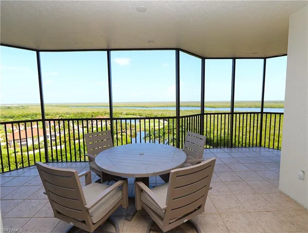 Sunroom / solarium featuring a water view