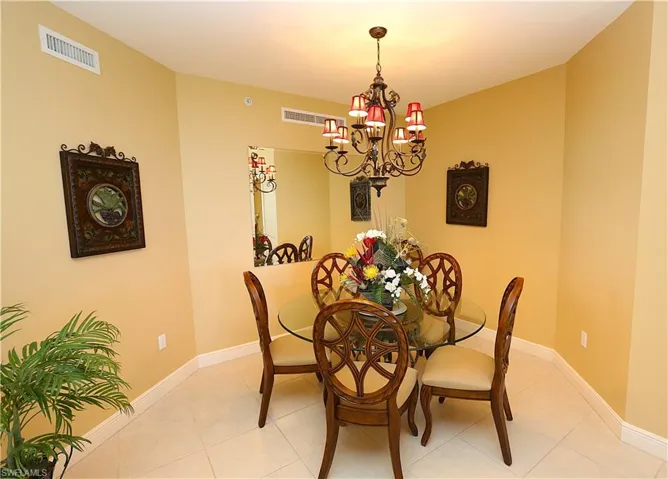 Dining room featuring light tile patterned floors and a chandelier