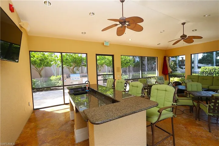 Sunroom with recessed lighting and stone tile flooring