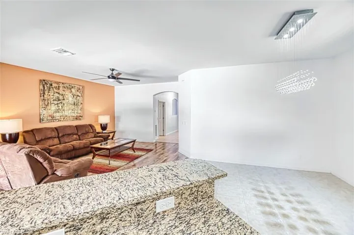 View from the kitchen to the main hall entrance. With a modern glass chandelier