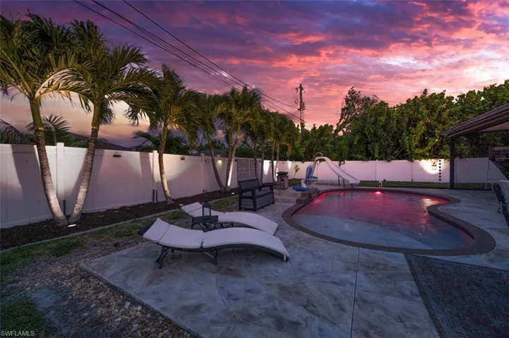 The sun is setting on your heated pool with nighttime lighting