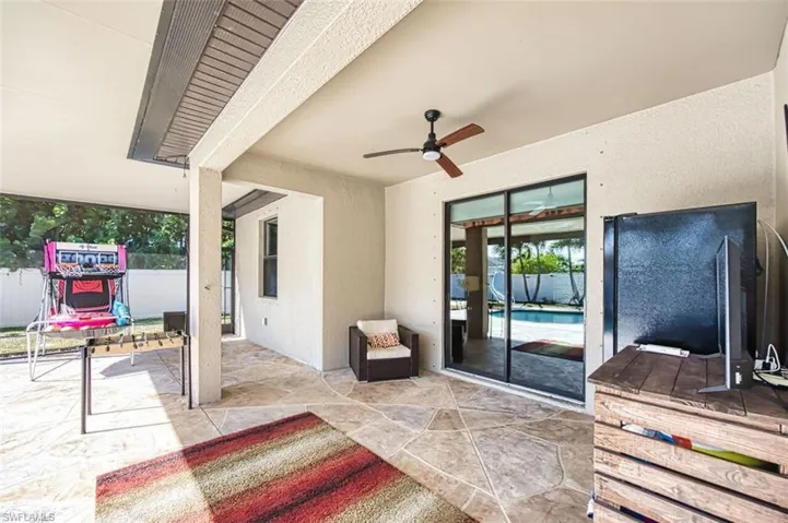 Entertain outdoors with TV, refrigerator, and roll-down electric screens