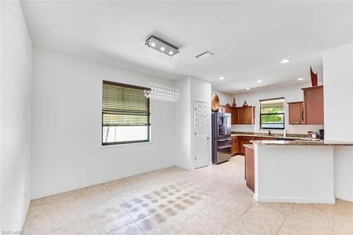 Dining area and Kitchen with modern chandelier